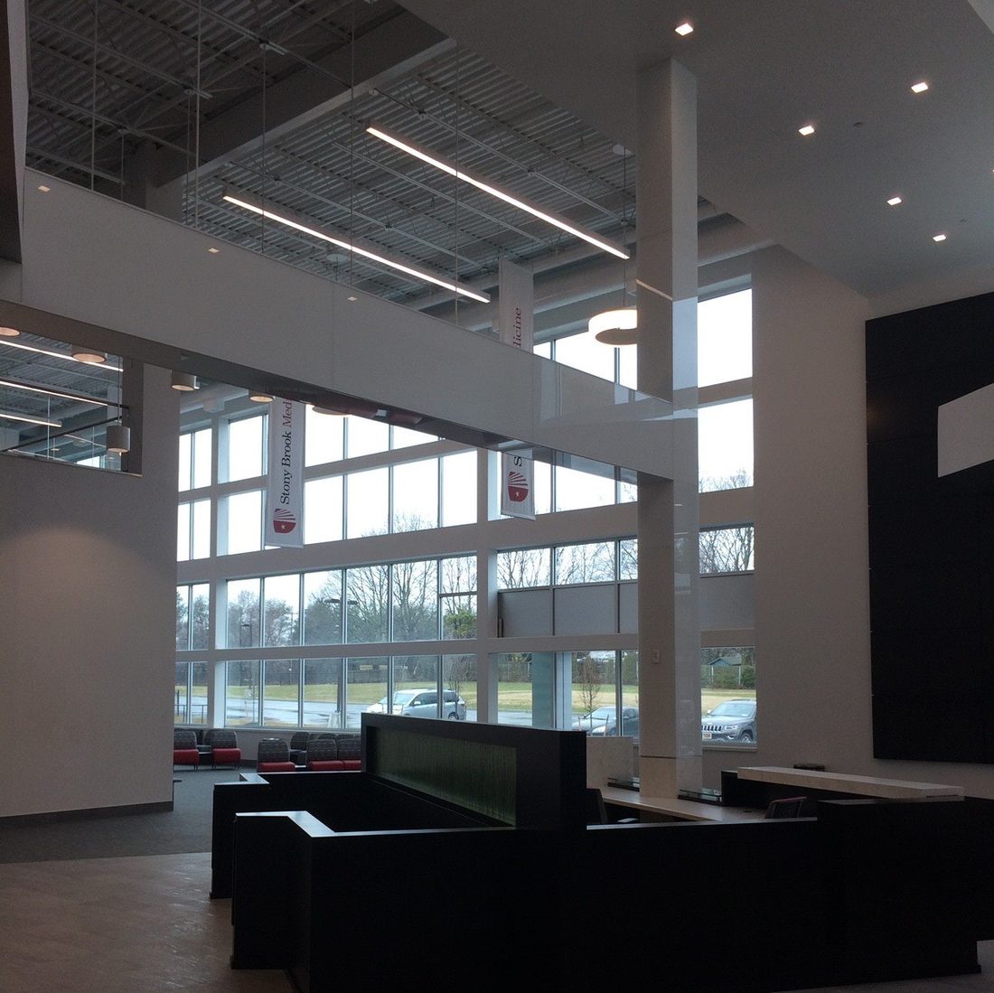 Floor-to-ceiling commercial glass curtain wall in a medical building lobby